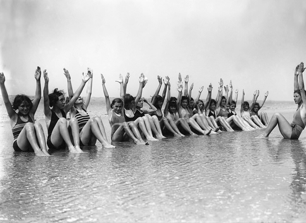 Young ladies in the middle of a gymnastics session along the sea in Deauville on July 22, 1937.