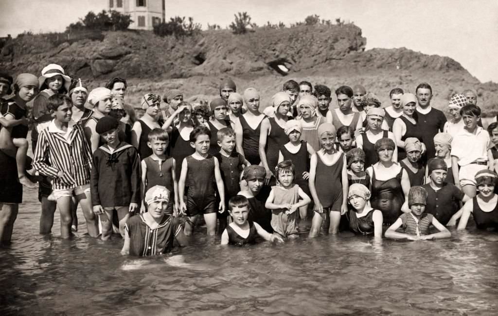 A group of holidaymakers posing on the beach at Deauville, 1920