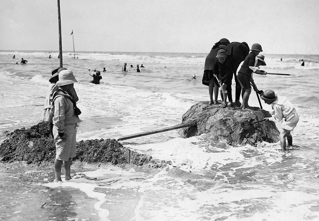 Deauville Children build sand-formations at the beach, 1913