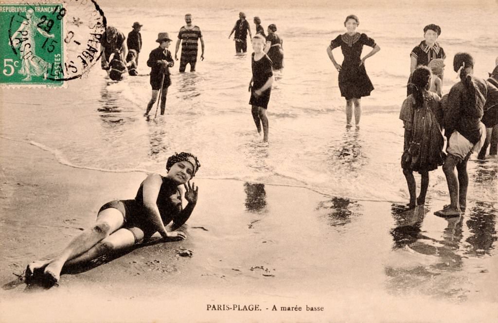 A group of holidaymakers in swmming costumes padddling in the sea at Deauville, 1910