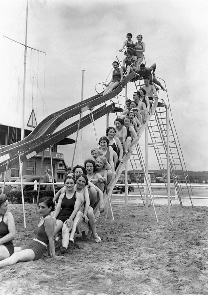 Vacationers in Deauville on a toboggan on the beach on July 7, 1936.