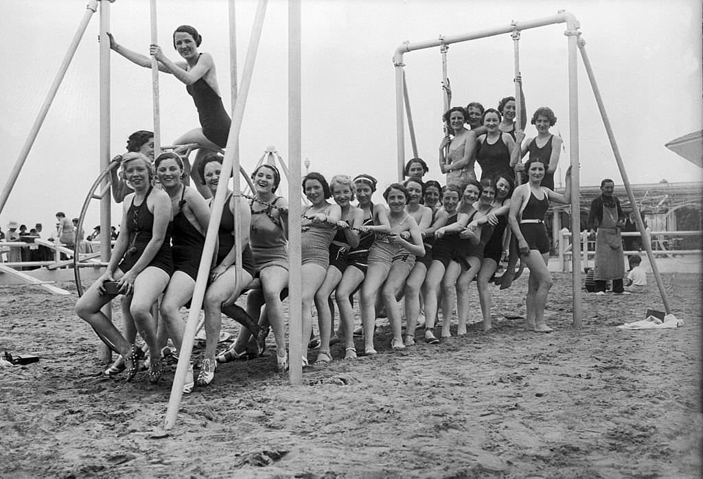 Two hundred Parisian dressmakers (young girls) on the Deauville beach, 1930s.