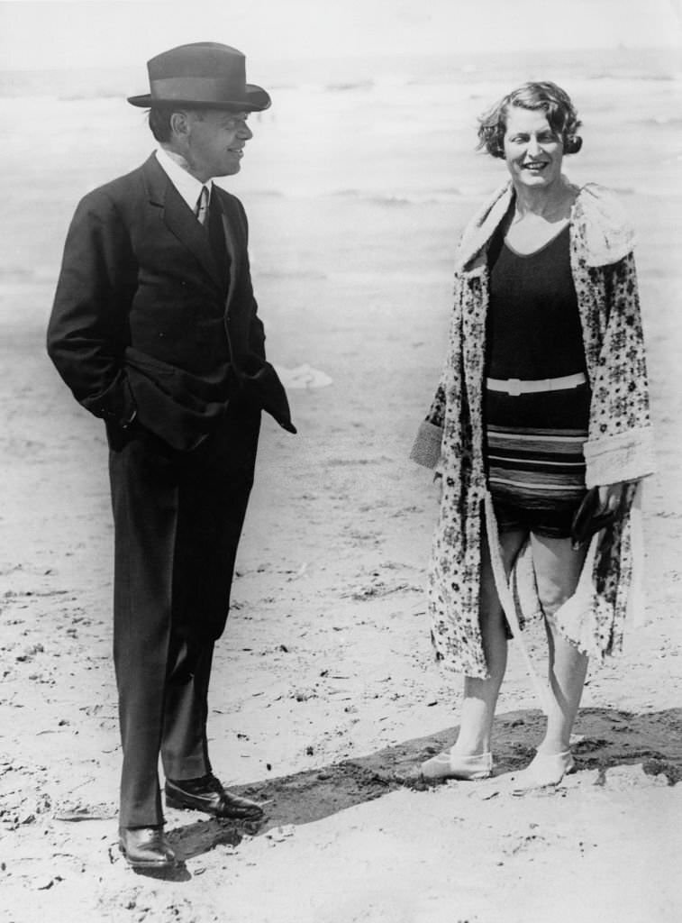 Canadian-British newspaper publisher and politician Max Aitken, 1st Baron Beaverbrook == chatting with Vera Edyth Griffith-Boscawen, Lady Broughton on a beach while on holiday in Deauville, 1930