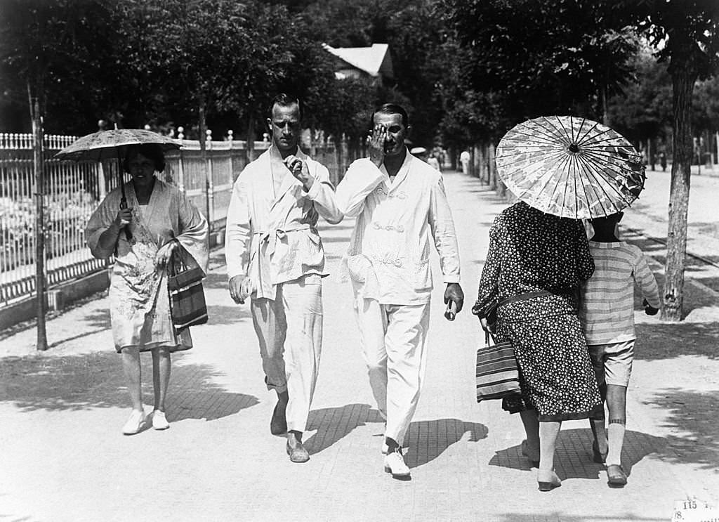 Two men in their beach outfit strolling in August 1929 in Deauville, France.