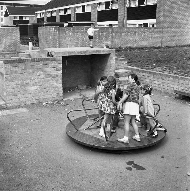 A group of children playing on a merry-go-round in Ballymun, August 1970.