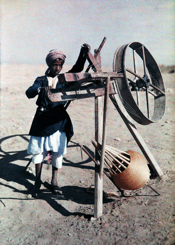 Boy reels silk in a desert near Cairo.
