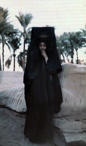 Woman in black attire posing.