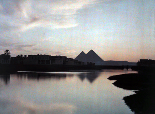 View of the pyramids with buildings in between.