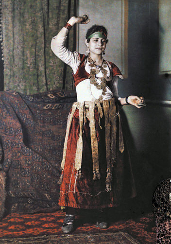 Young cabaret dancer posing for a photograph in traditional clothing.