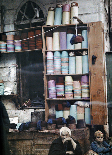 Egyptian street merchant sells hats.