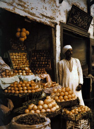 Orange merchant awaits customers.