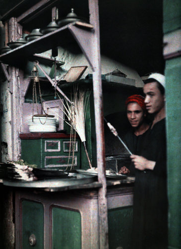 Two boys cooking meat at a meat shop in Egypt.