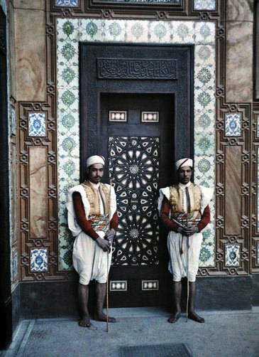 Two sais stand in front of the entrance to the French Legation.