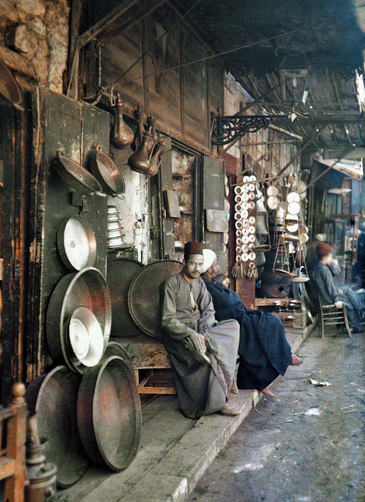 Man sitting next to his store for the Egyptian version of a washtub.