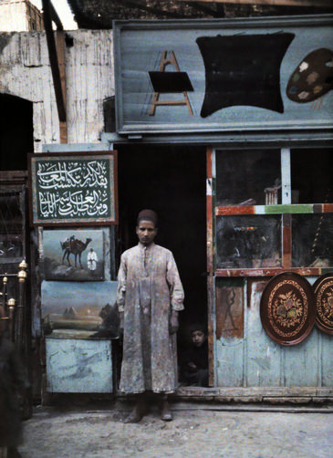 Painter standing in the doorway of his shop.