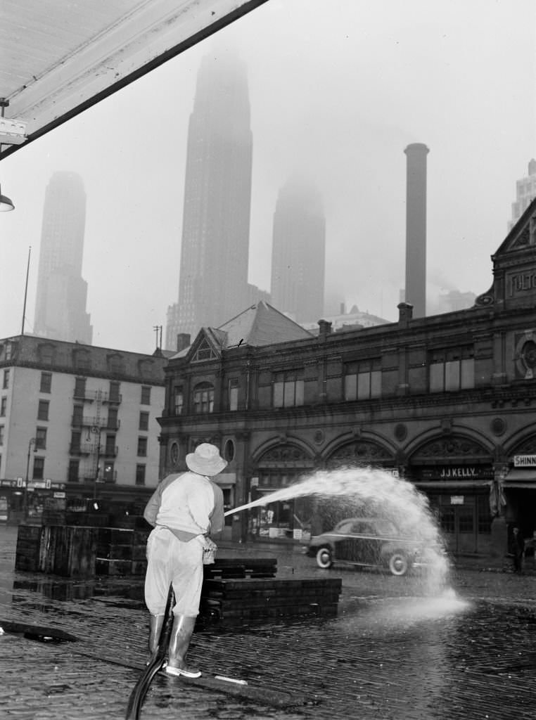 City Sanitation Workman Washing Streets at Fulton Fish Market