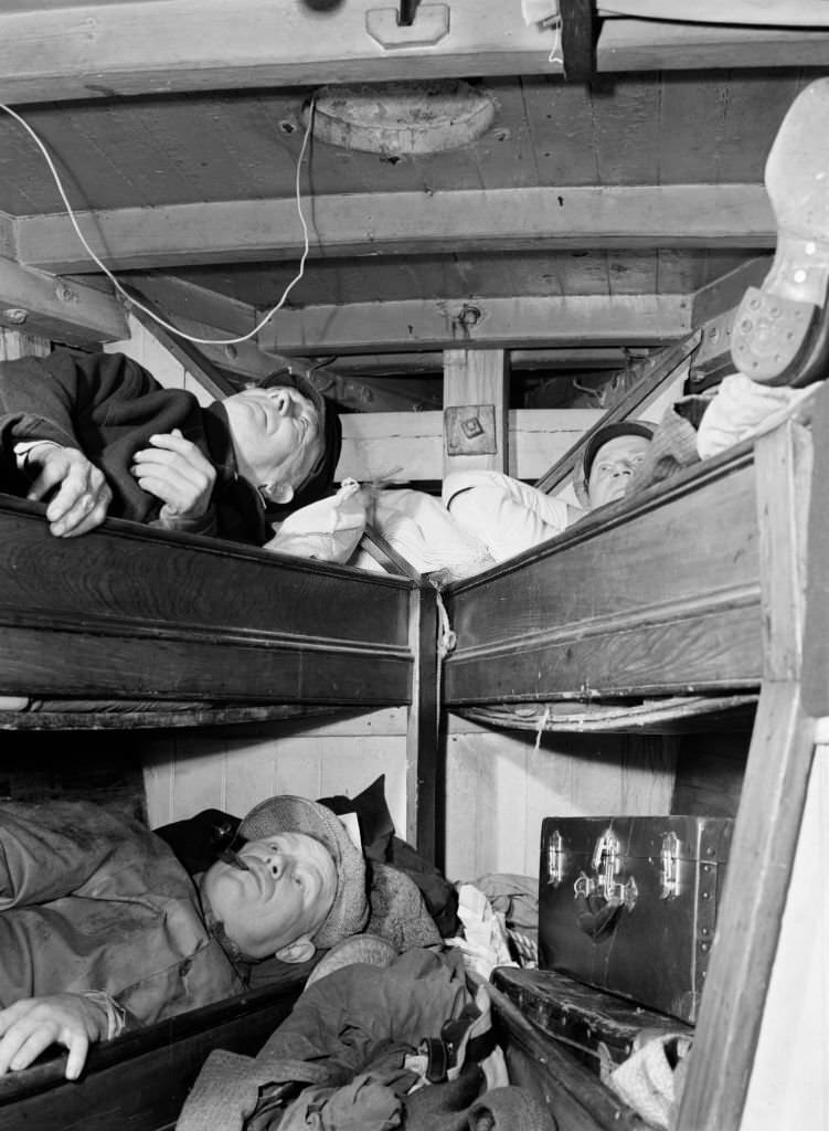 Gloucester fishermen resting in their bunks after unloading their catch at the Fulton fish market.