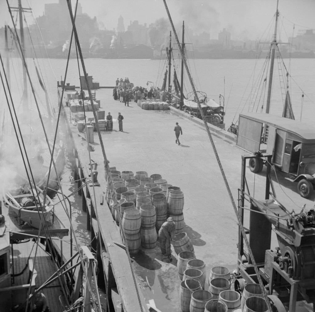 A scene at the Fulton fish market showing the dock where New England fishing boats unload their cargo.