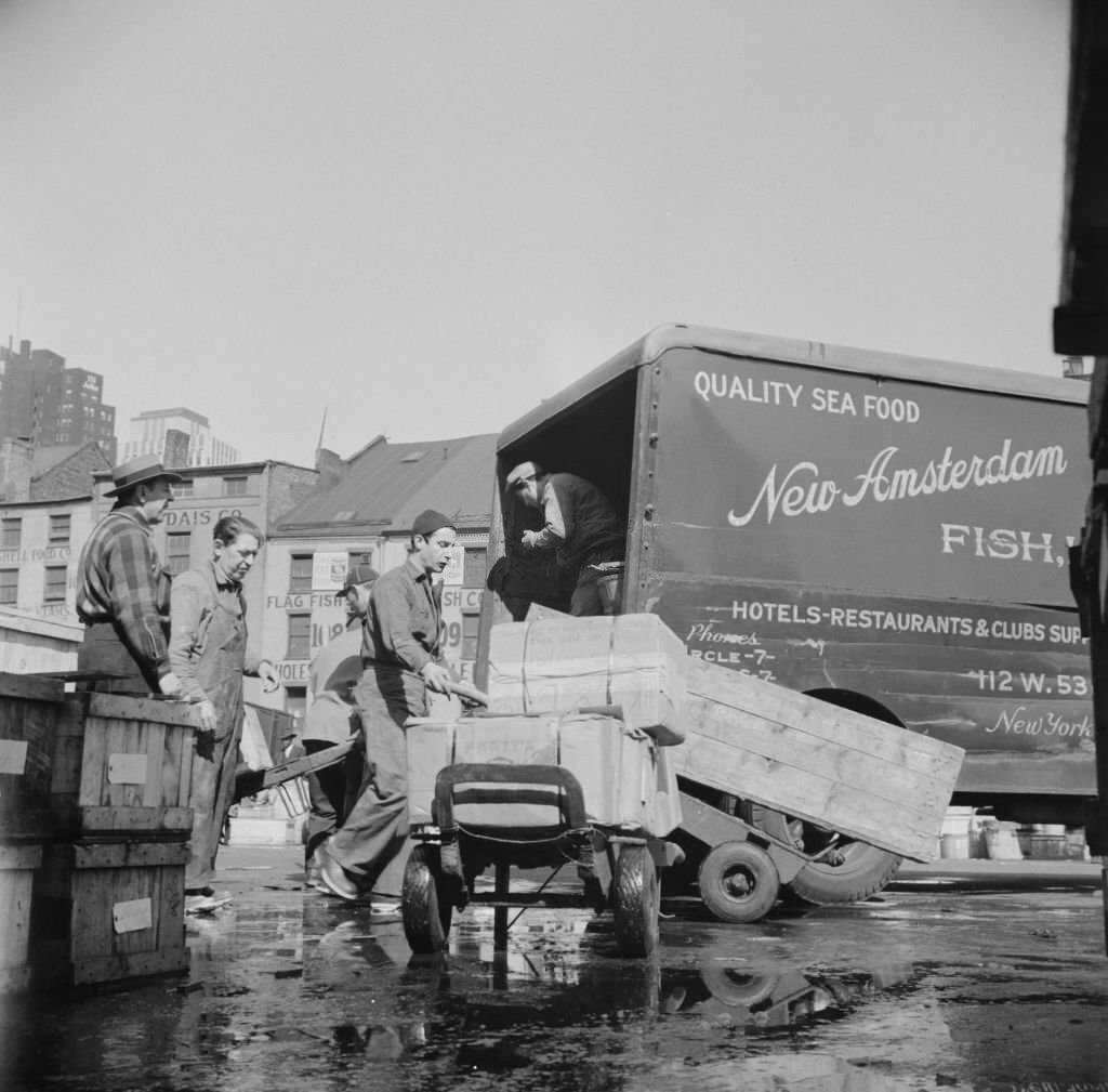Loading boxes of fish to be shipped to hotels and restaurants at the Fulton fish market, 1934