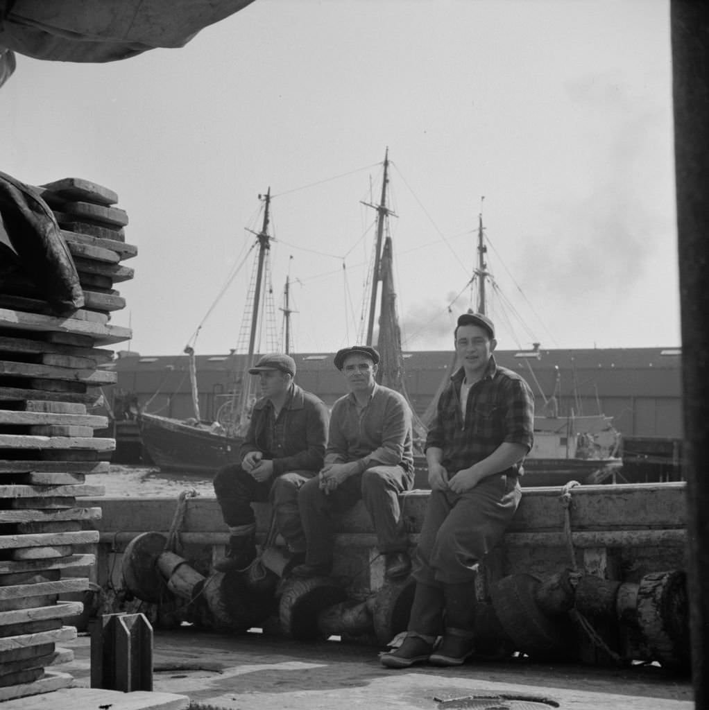 Gloucester fishermen resting on their boat at the Fulton fish market, 1930s