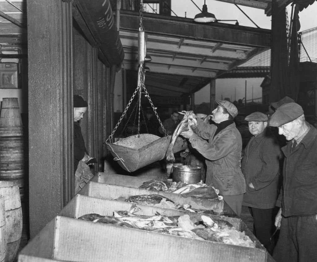 Fulton Fish Market fishmongers at work in the early hours of the morning, New York, 1949.