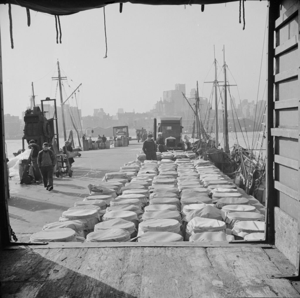 Barrels of fish on the docks at Fulton fish market ready to be shipped to retailers and wholesalers, 1920s