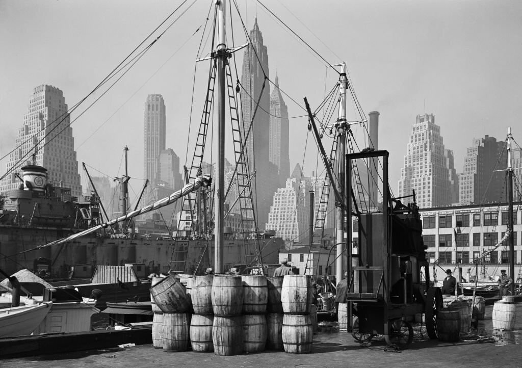 View of the Fulton Fish Market wharf with the Manhattan skyline in the background, New York City, 1946.