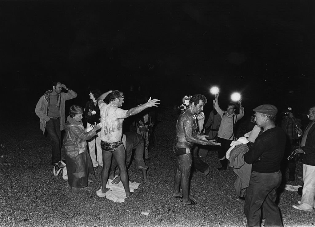 Two channel swimmers being greased up for a night swim, Grease, 1978