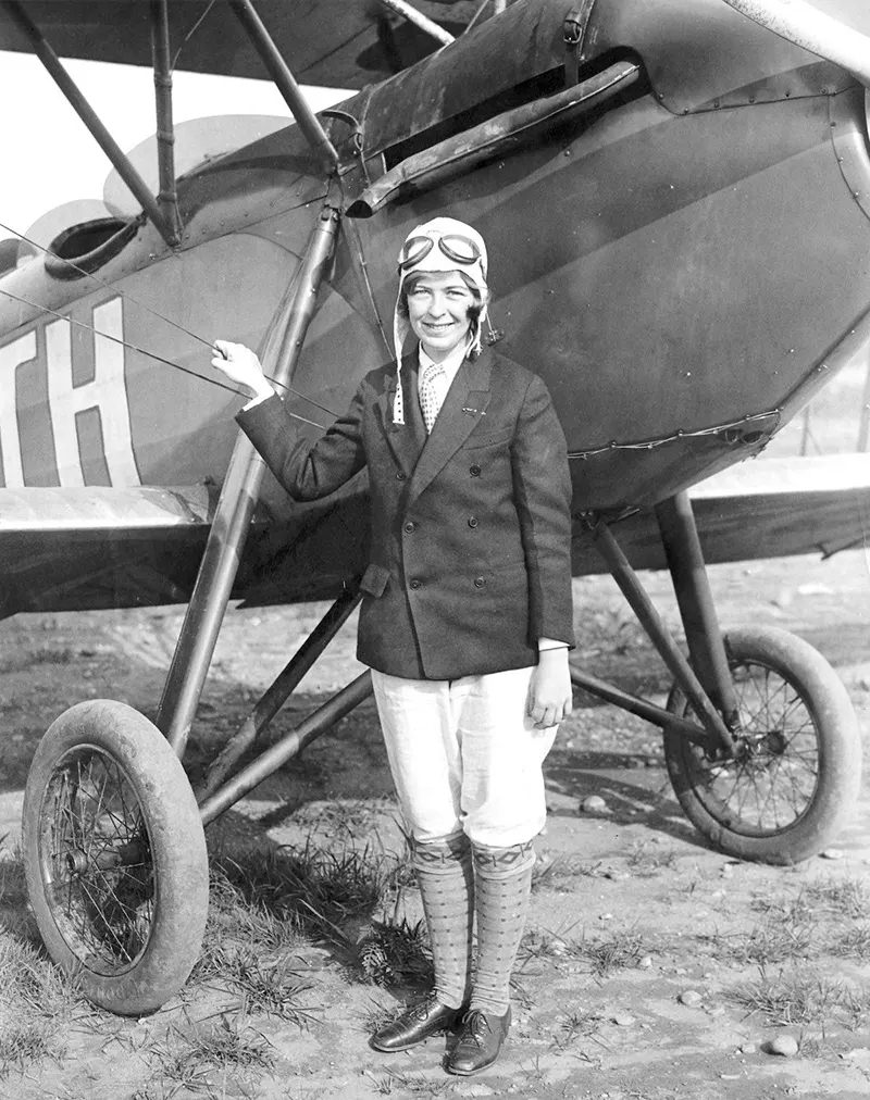 “Elinor Smith, 16, who will use the Waco plane beside which she is standing in an attempt to set a new altitude record for women, 1927