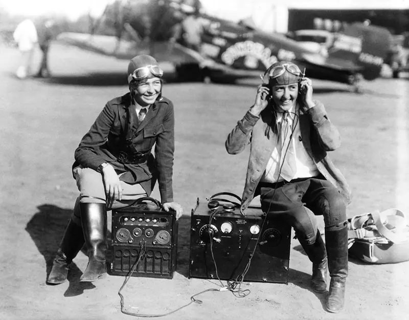“Miss Elinor Smith of New York, and Miss Bobby Trout of Los Angeles with the radio equipment which they will take up on the first woman’s refueling flight for endurance, 1927