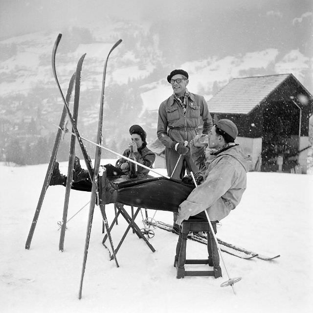 People have a drink while skiing near the cable car line departure station in Saint-Gervais-les-Bains, France, February 1949.