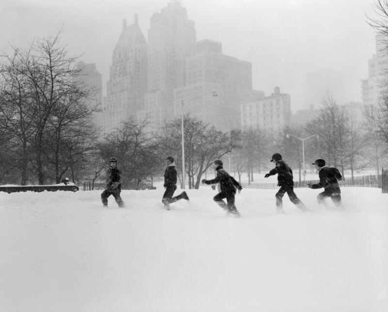 Youngsters frolicking through the snow in Central Park, 1958.