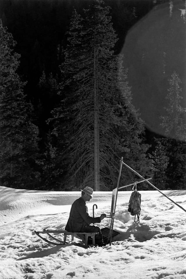 A painter painting during the winter, Dolomites, Monzon, 1959.