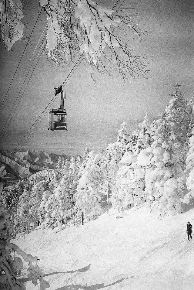 Ski lifts above a snowy scene near Shiga Kogen ski resort in Yamanouchi, Nagano, Japan, February 1961.