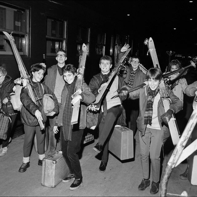 Young people with skis on their shoulders meet at gare de Lyon in Paris to depart for the winter sports holiday a few days before Christmas, December 1965.