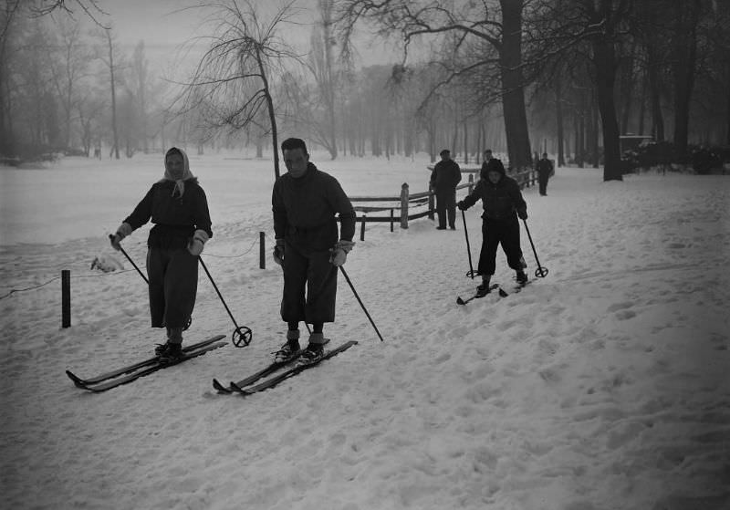 A family goes skiing in the Bois de Vincennes near Paris, France, January 1945.