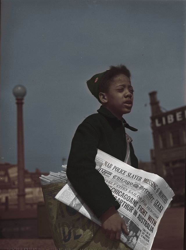 Newsboy selling the Chicago Defender, a leading Negro newspaper, Chicago, Illinois, April 1942