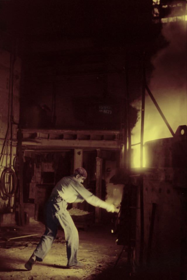 At the electric furnace in the foundry at the Farrell-Birmingham Company, Ansonia, Connecticut, November 1940
