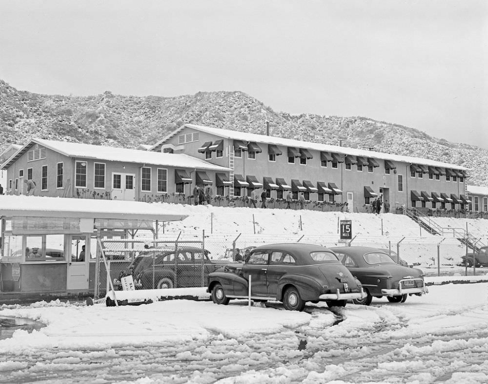 Rocky chaparral foothills stand above a snowy Jet Propulsion Laboratory in Pasadena/La Cañada Flintridge.