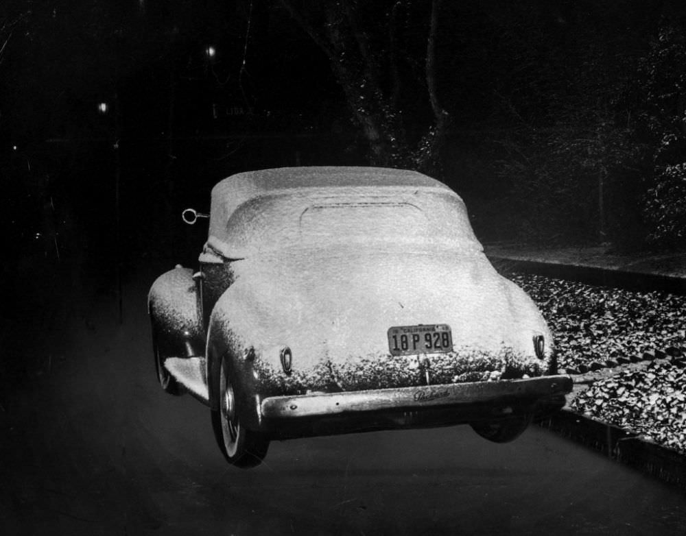 An automobile parked near the Rose Bowl at Linda Vista Avenue and Lida Street sits covered with snow.