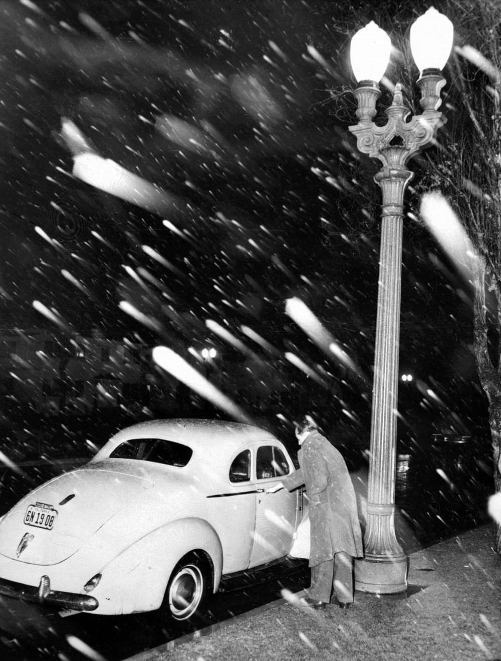 Snow falls on Santa Barbara Avenue near Crenshaw Boulevard in South Los Angeles.