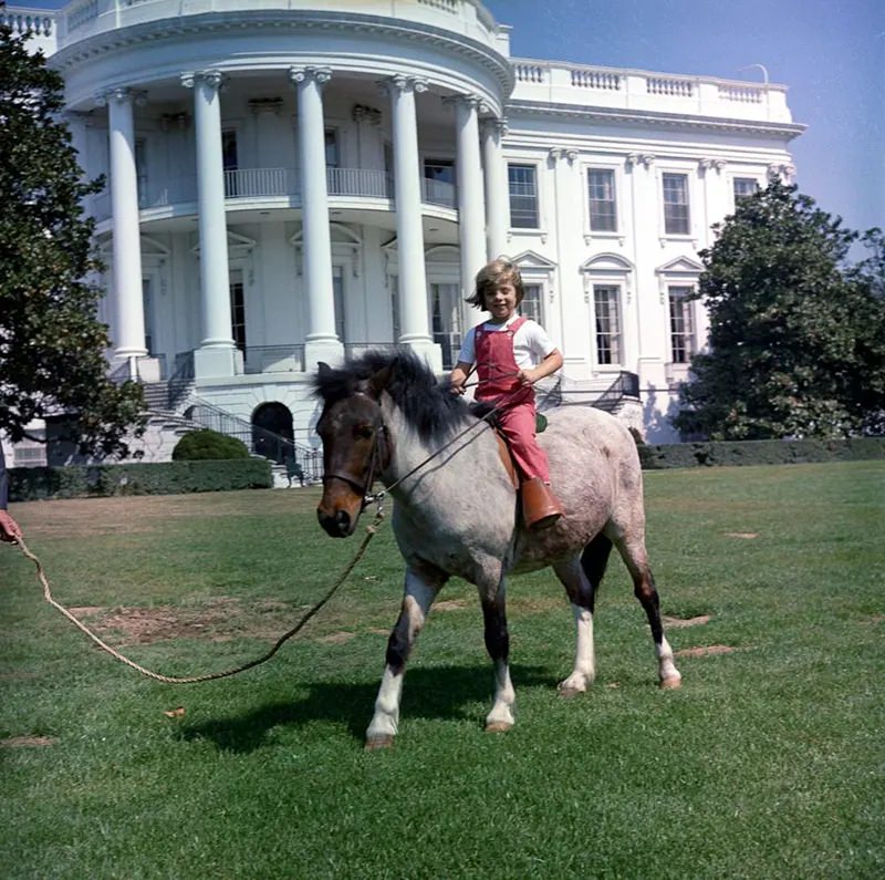 Caroline Kennedy sits astride Macaroni on the South Lawn of the White House.