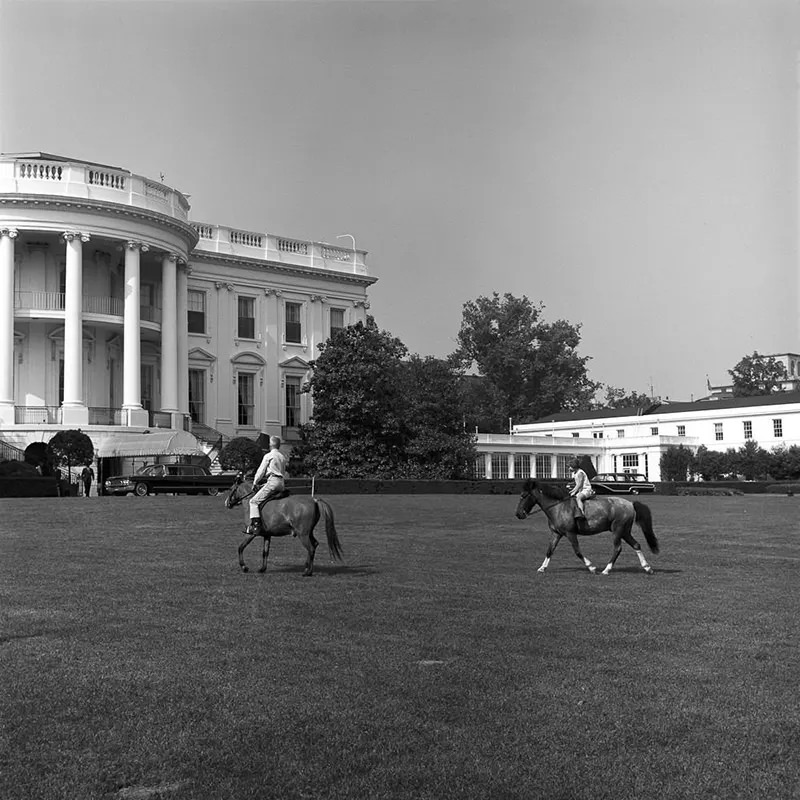 Caroline Kennedy rides Macaroni while an unidentified boy rides Tex.