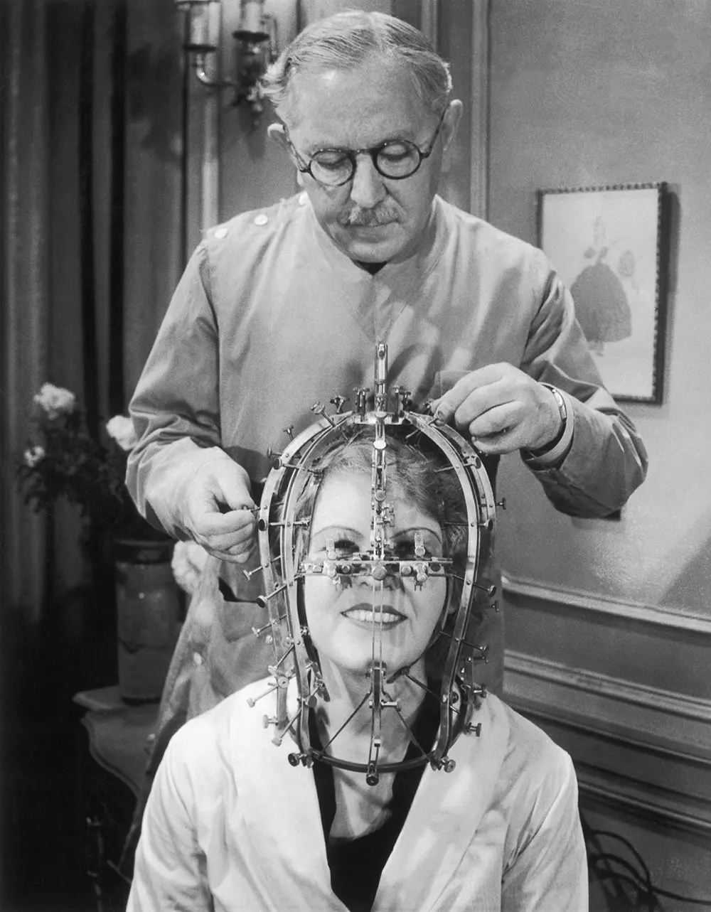 Max Factor takes measurements of actress Marjorie Reynolds’ facial features using a beauty micrometer