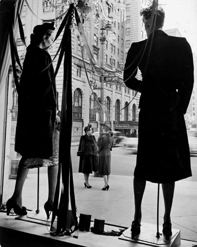 In front of the window display at Bergdorf Goodman, Fifth Avenue, New York City, 1942.