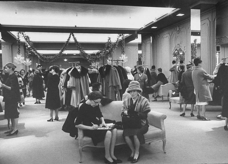 Shoppers in the women's coat dept. of Saks Fifth Ave. department store, 1960.