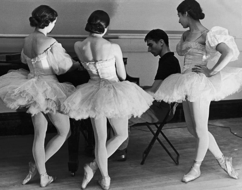 Ballerinas at George Balanchine’s American School of Ballet gathered around accompanist during rehearsal, 1936.