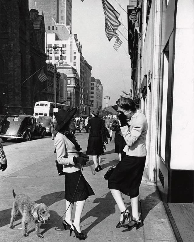 Two women talking on the sidewalk of Fifth Avenue in midtown, New York, 1942.