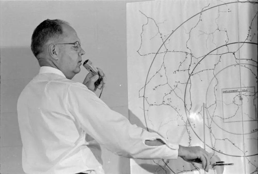 Henry G. Vermillion, office of information director, U.S. Atomic Energy Commission, indicates evacuation area for the 1964 nuclear test site.