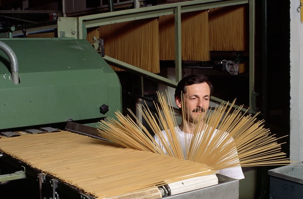 A man examines spaghetti at the Buitoni pasta factory in Sansepolchro, Italy.